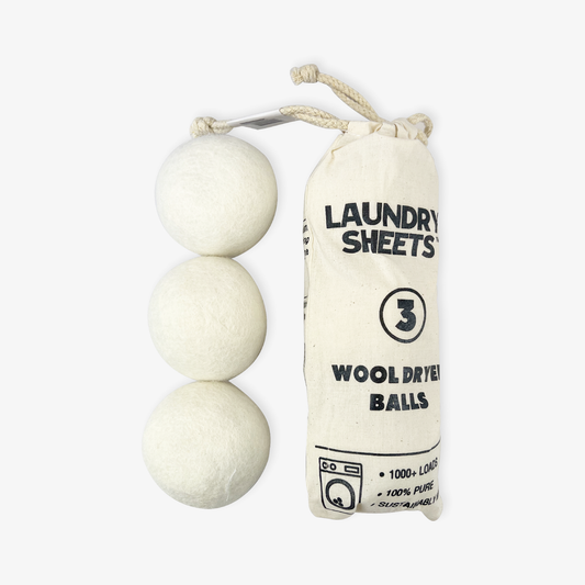Pack of three wool dryer balls next to organic cotton storage pouch